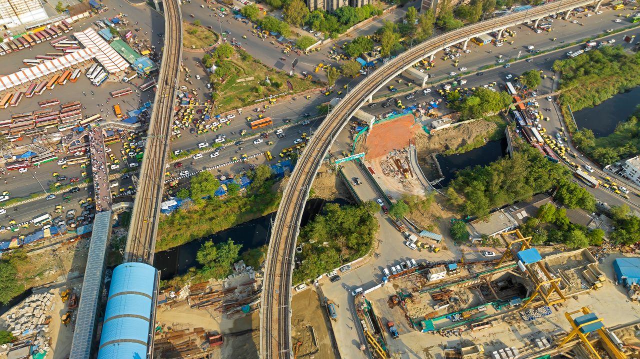Drone shot of busy urban area with roads, construction, and transportation